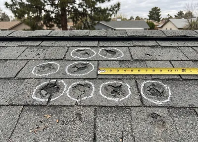 Hail-damaged roof shingles, close view