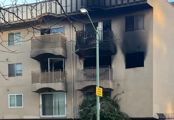Apartment building with fire damage to the upper units.