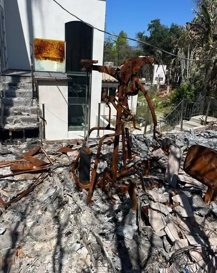 Fire-gutted interior with charred framing, field photograph.